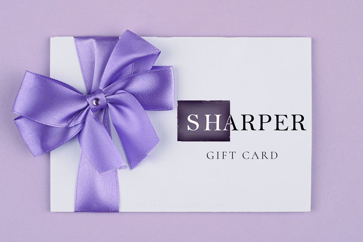 Gift card with purple bow on pastel background.