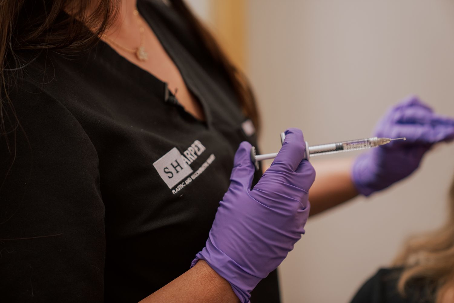 SHarper Plastic Surgery, Spa + Salt Lounge staff holding syringe
