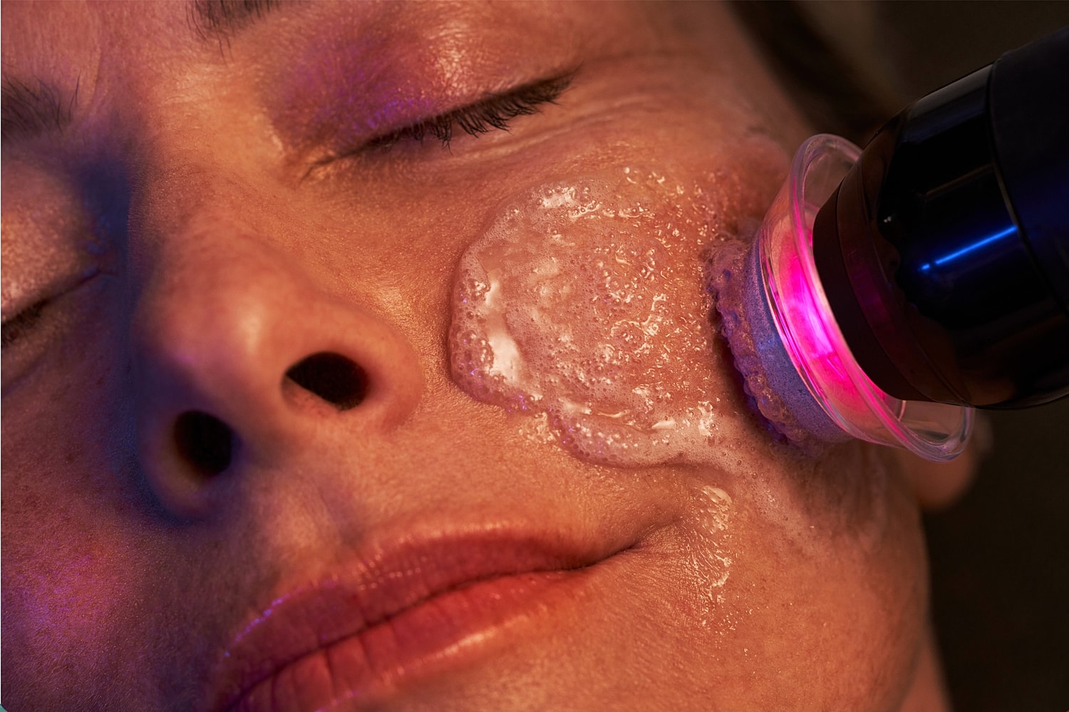 Facial treatment with a cleansing device.