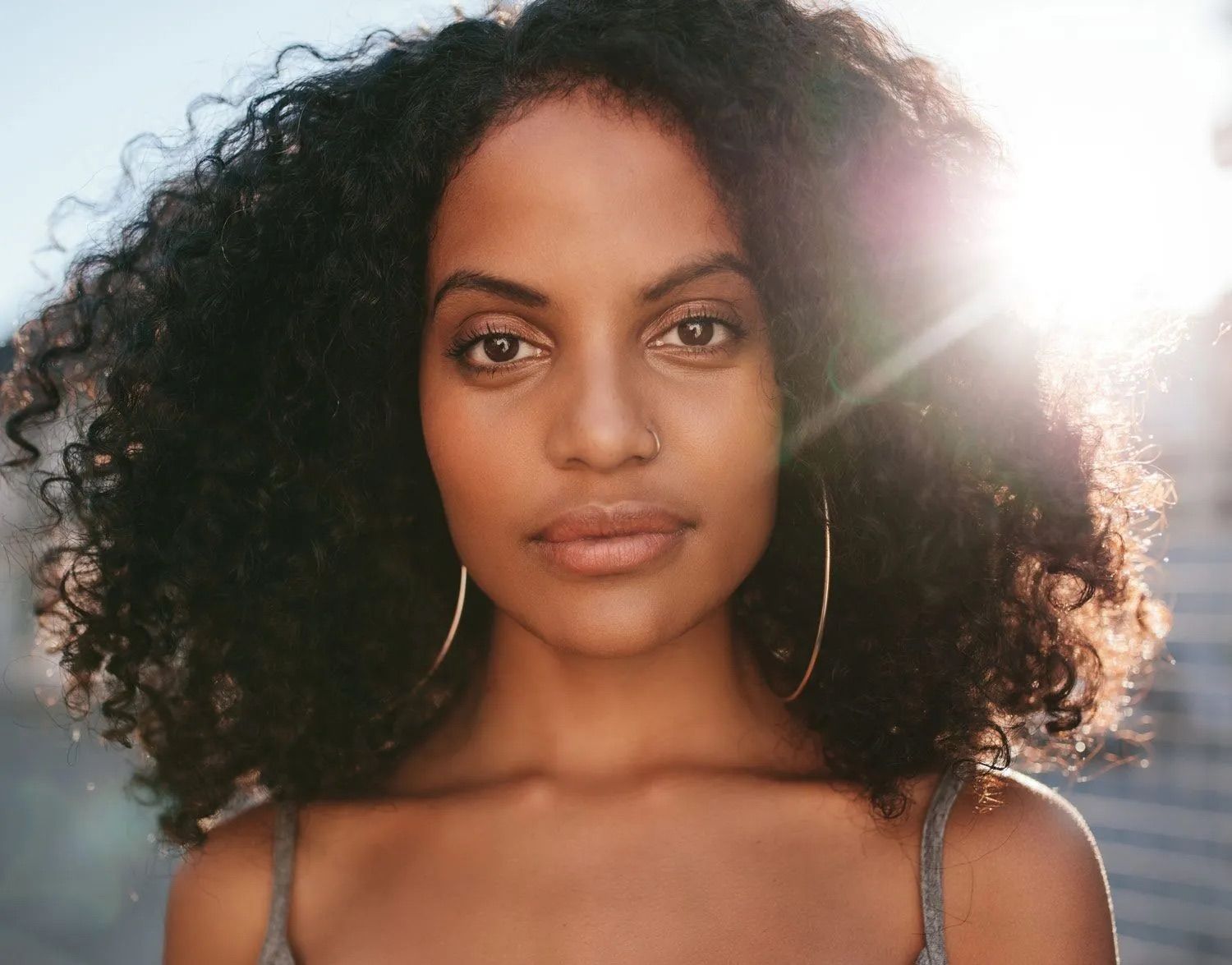 Woman with curly hair and natural sunlight.