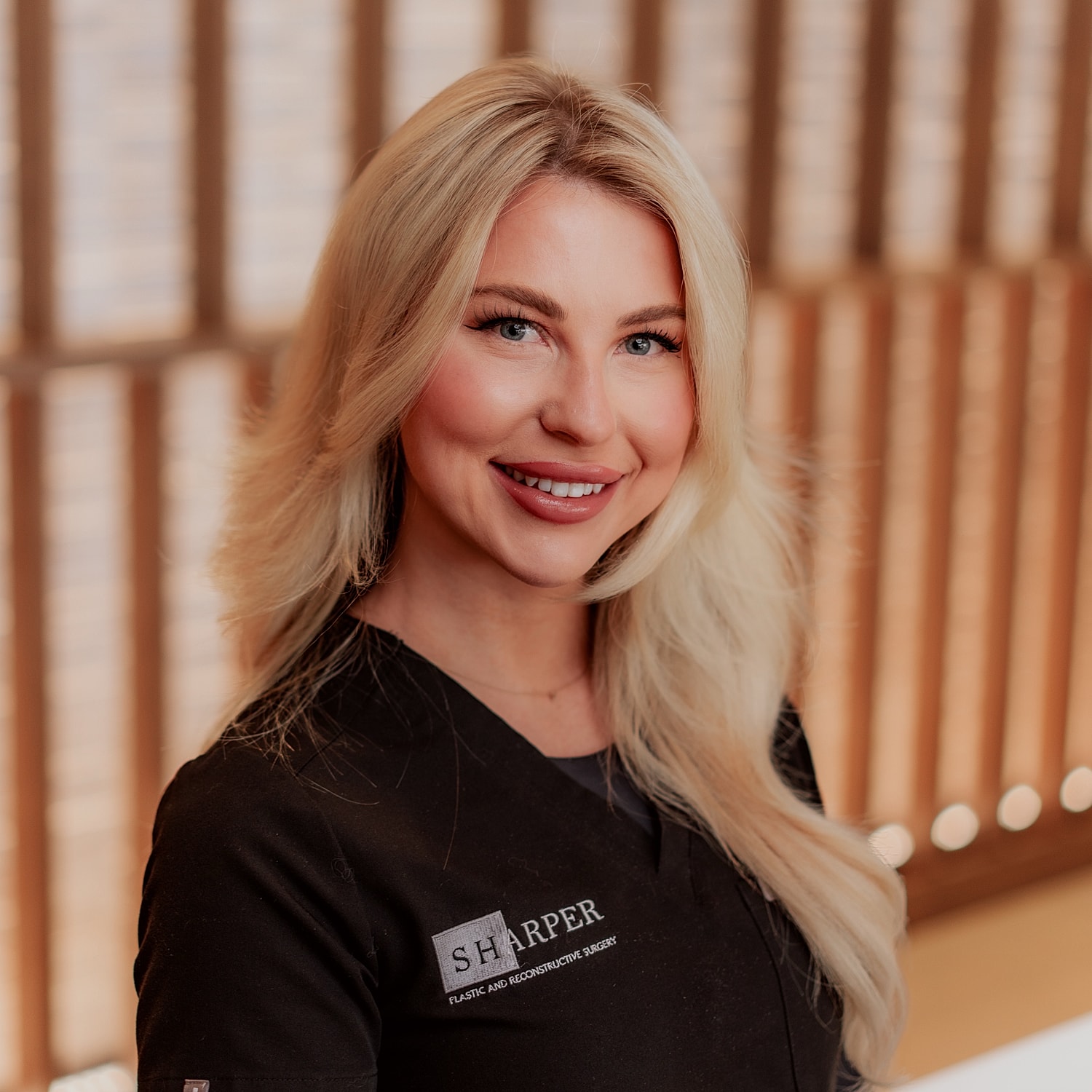 Smiling woman in professional attire indoors.