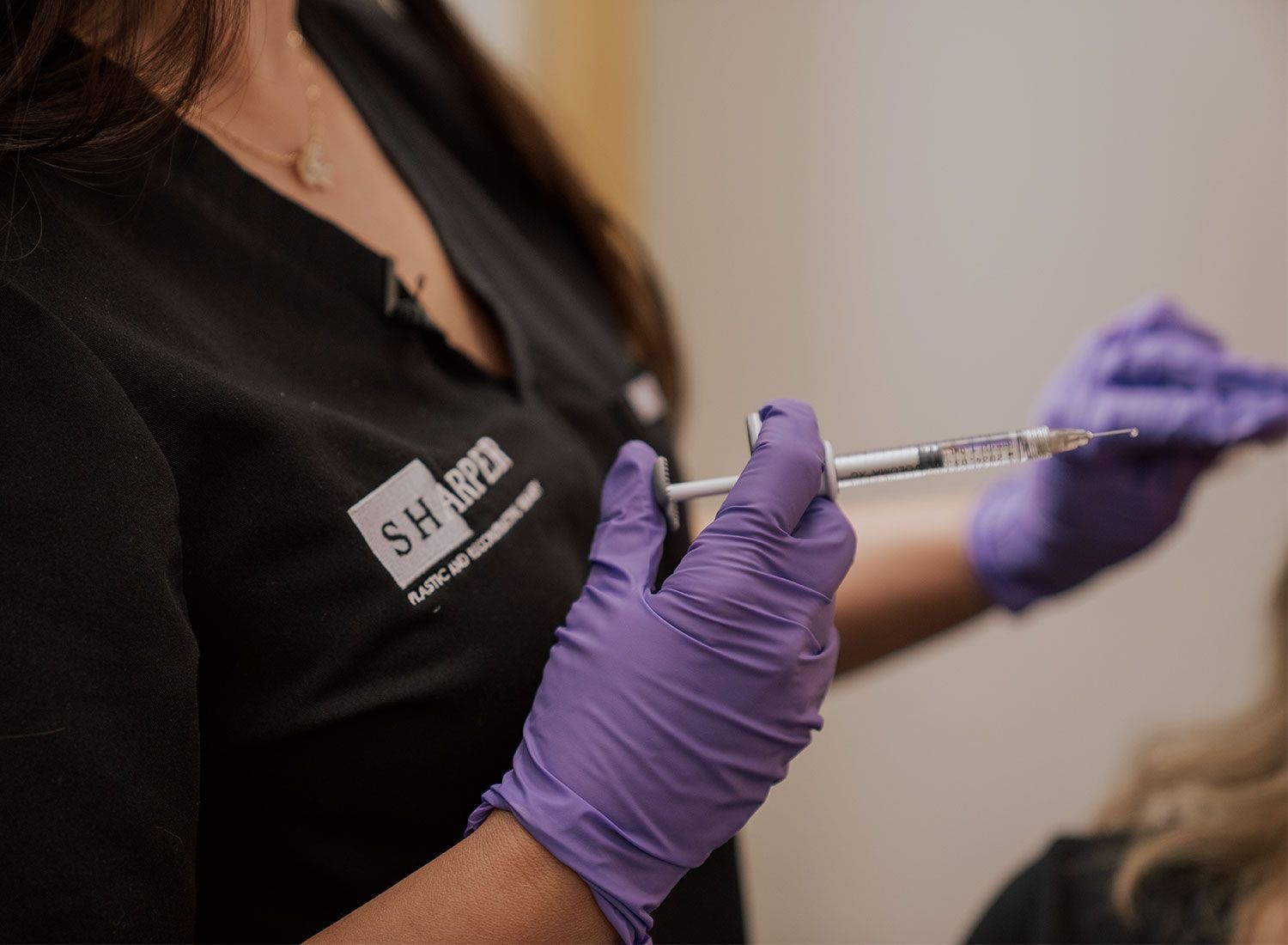 indianapolis dermal fillers specialist holding syringe