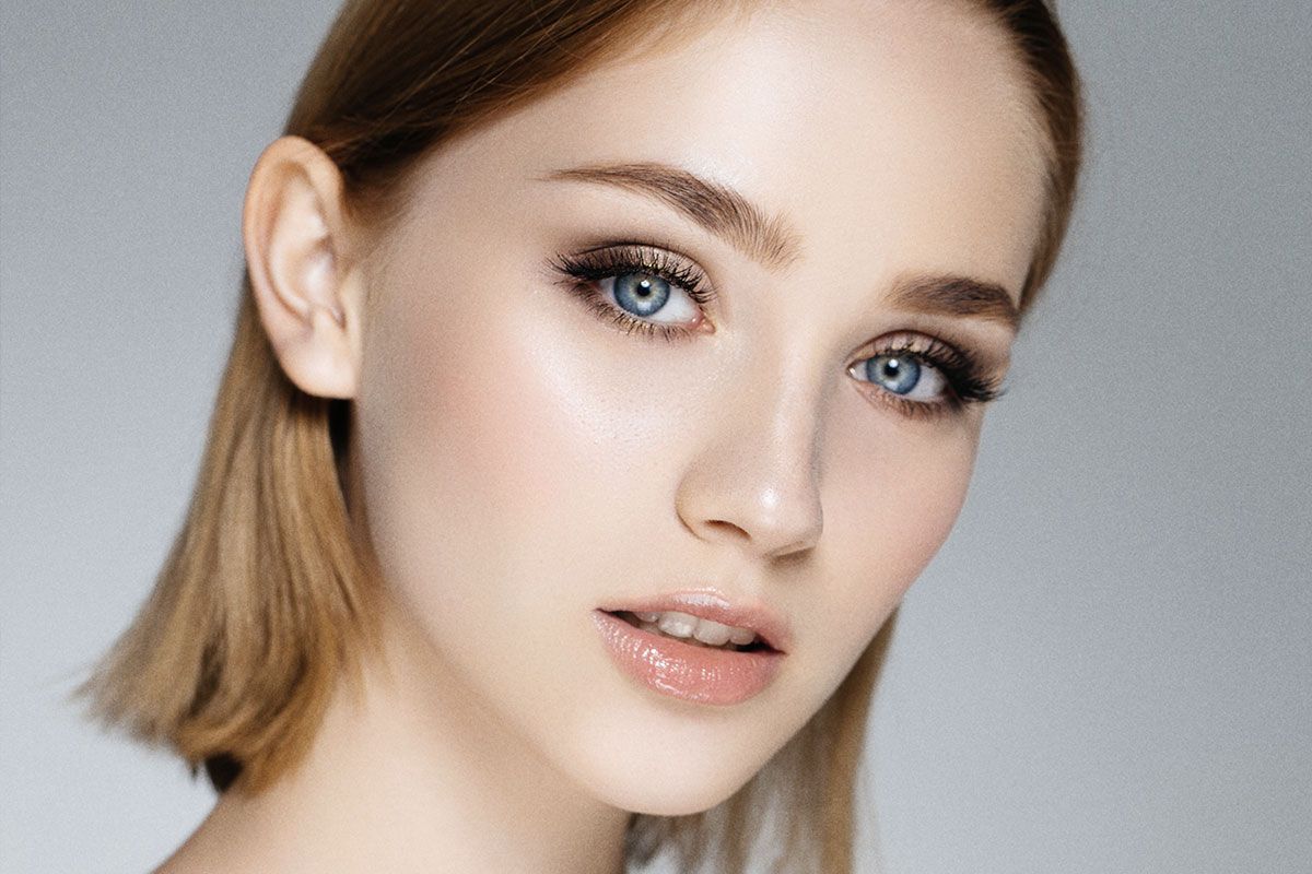 Close-up portrait of a young woman with makeup.