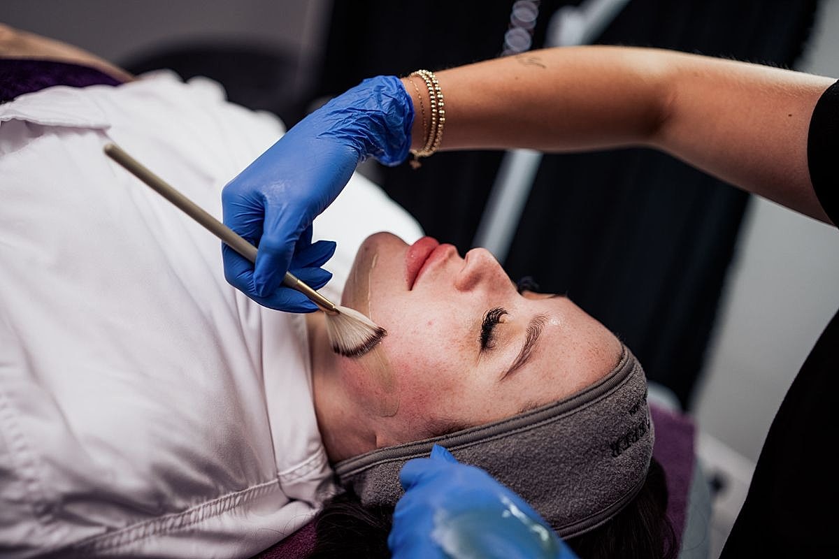 Facial treatment in progress at beauty salon.