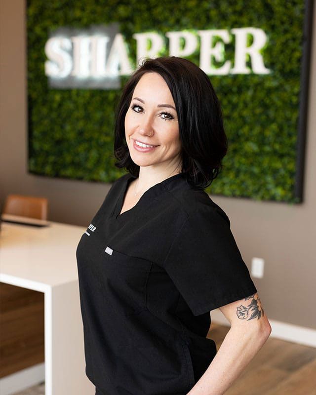 Smiling woman in professional attire at office.
