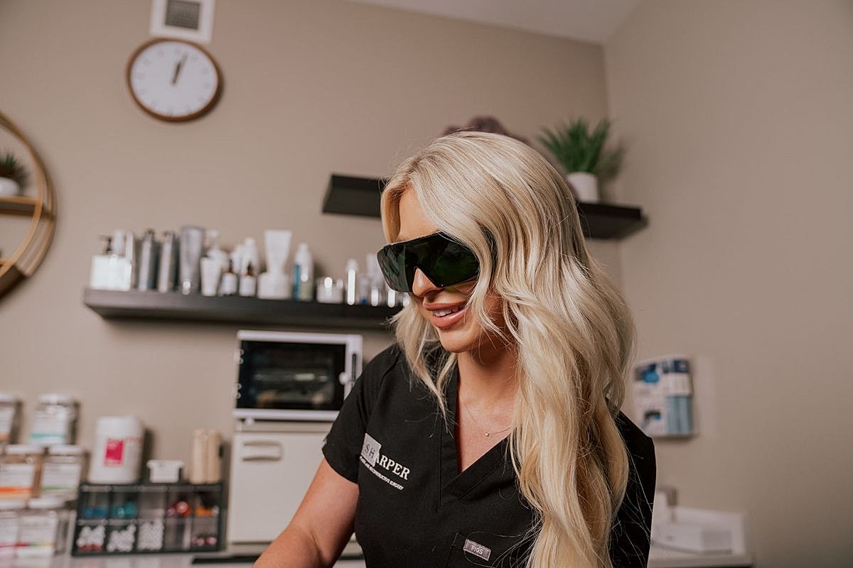 Woman with blonde hair in salon environment.