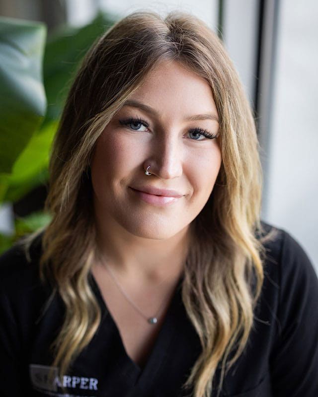 Smiling woman with long hair indoors.