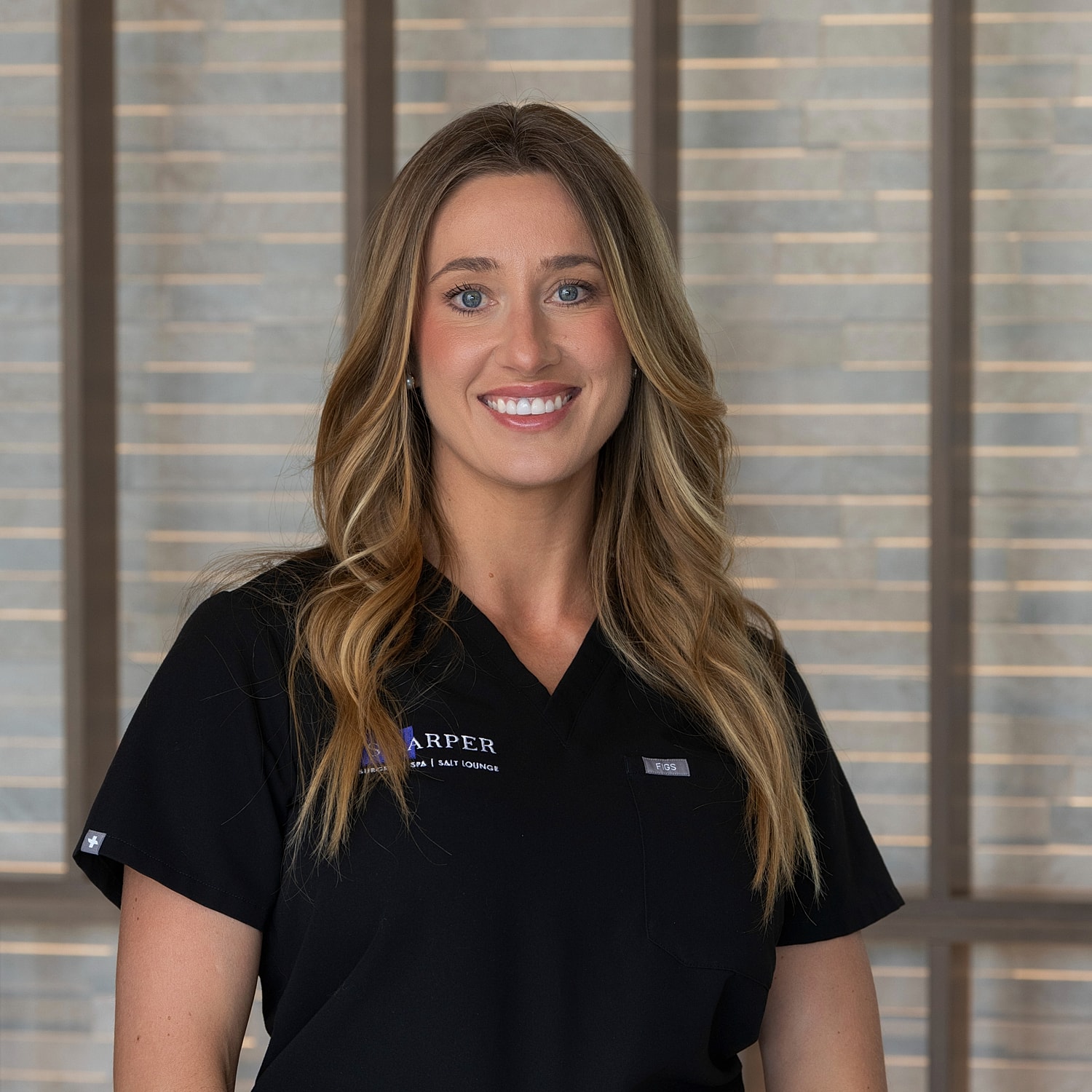 Healthcare professional smiling in a clinic setting.
