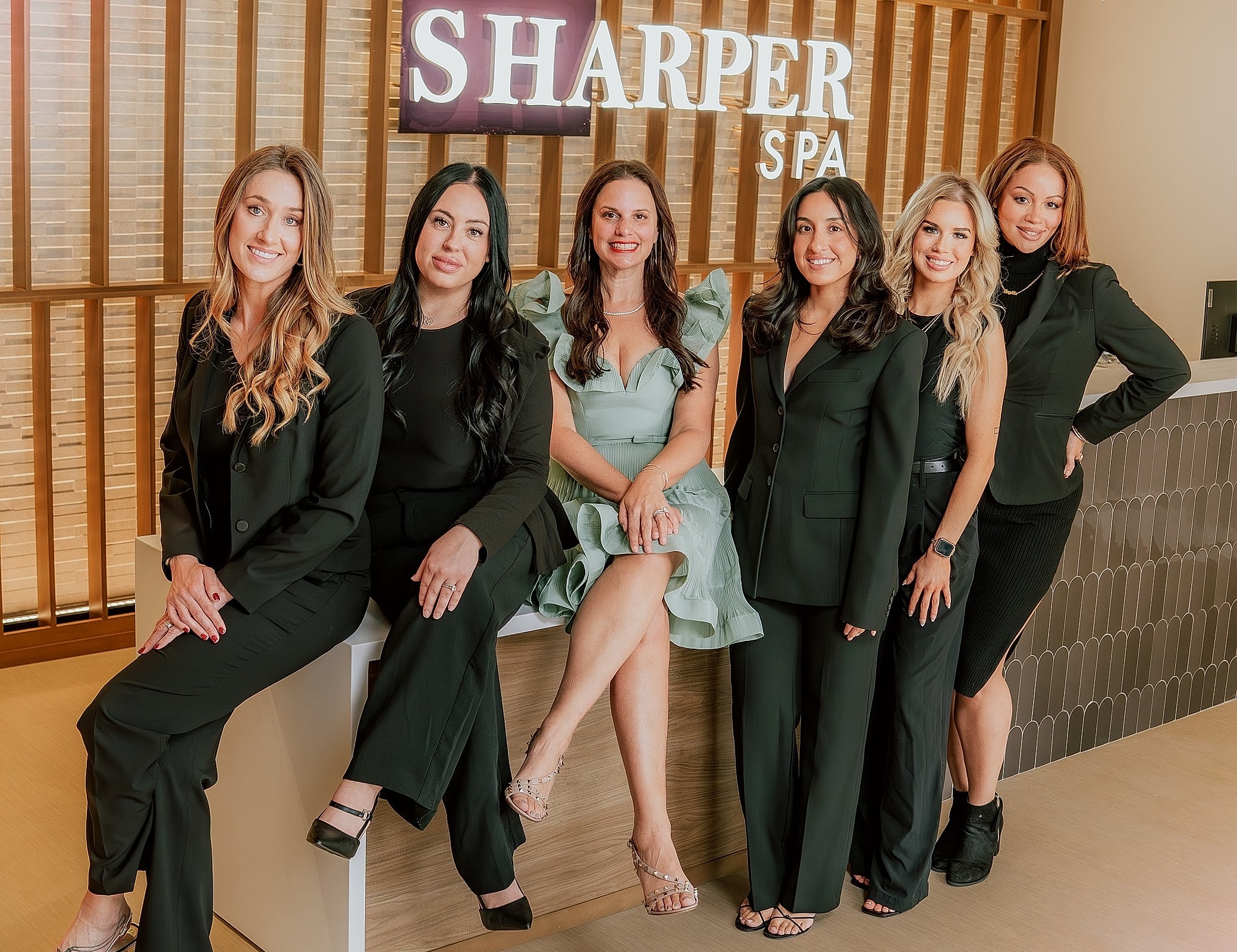 Business sign with floral decor for Sharper Spa