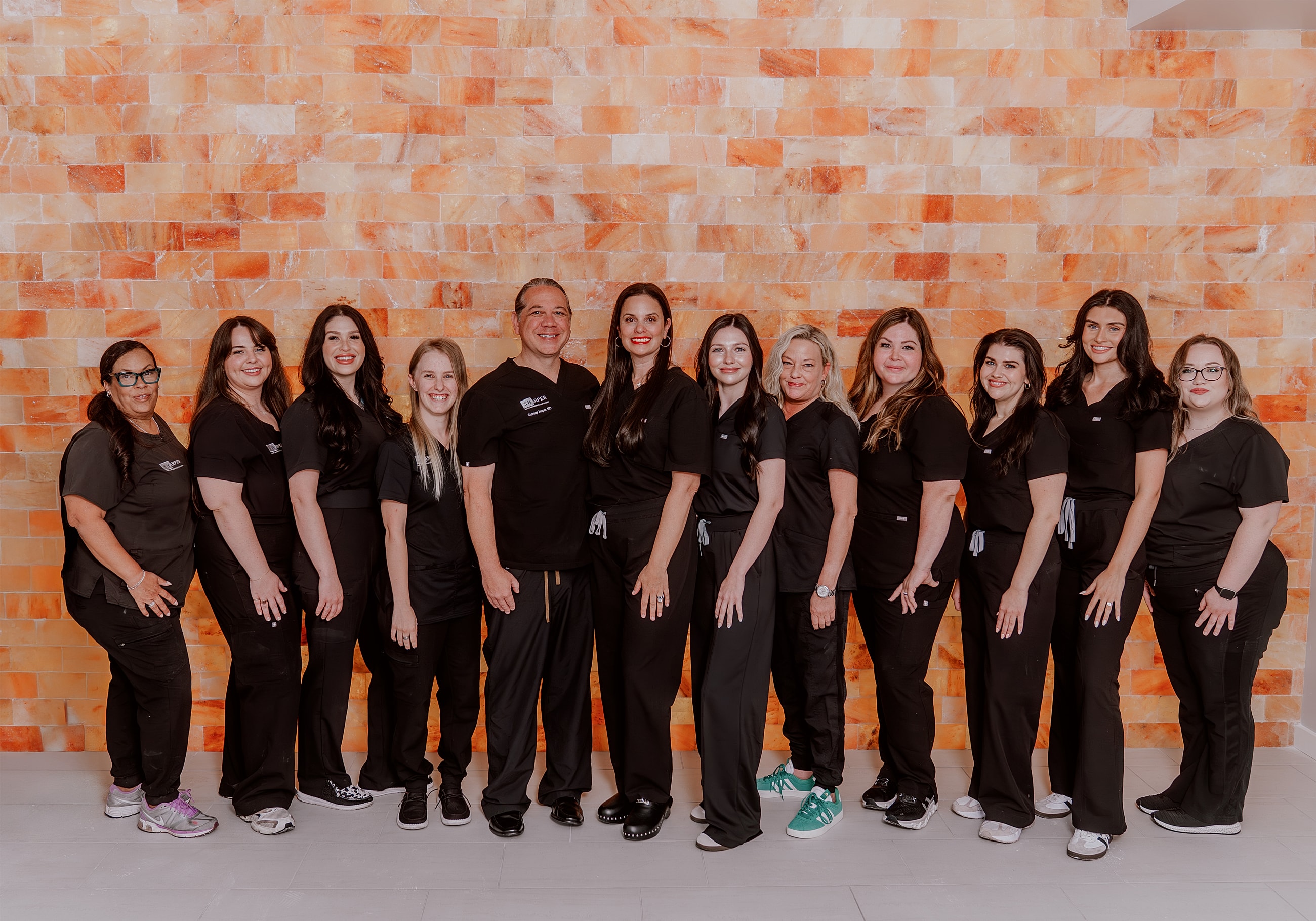 Group of professionals posing together for photo.