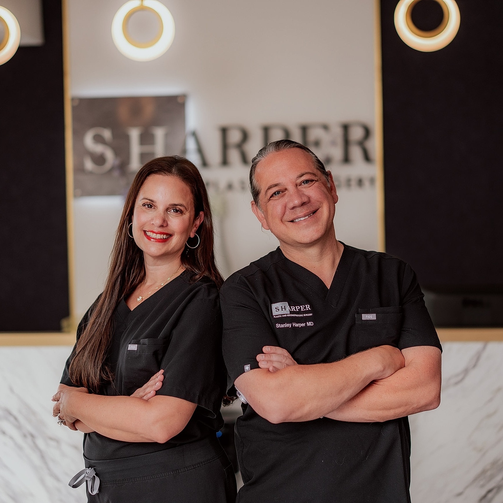 Medical professionals smiling in clinic setting.