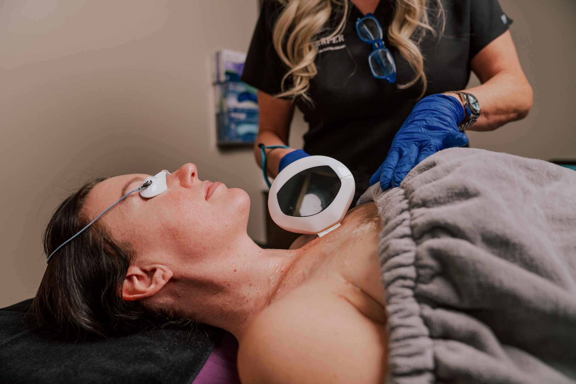 Woman receiving a skin treatment in a clinic.