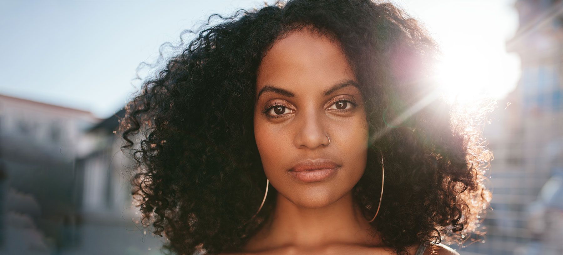 Portrait of a woman with curly hair.