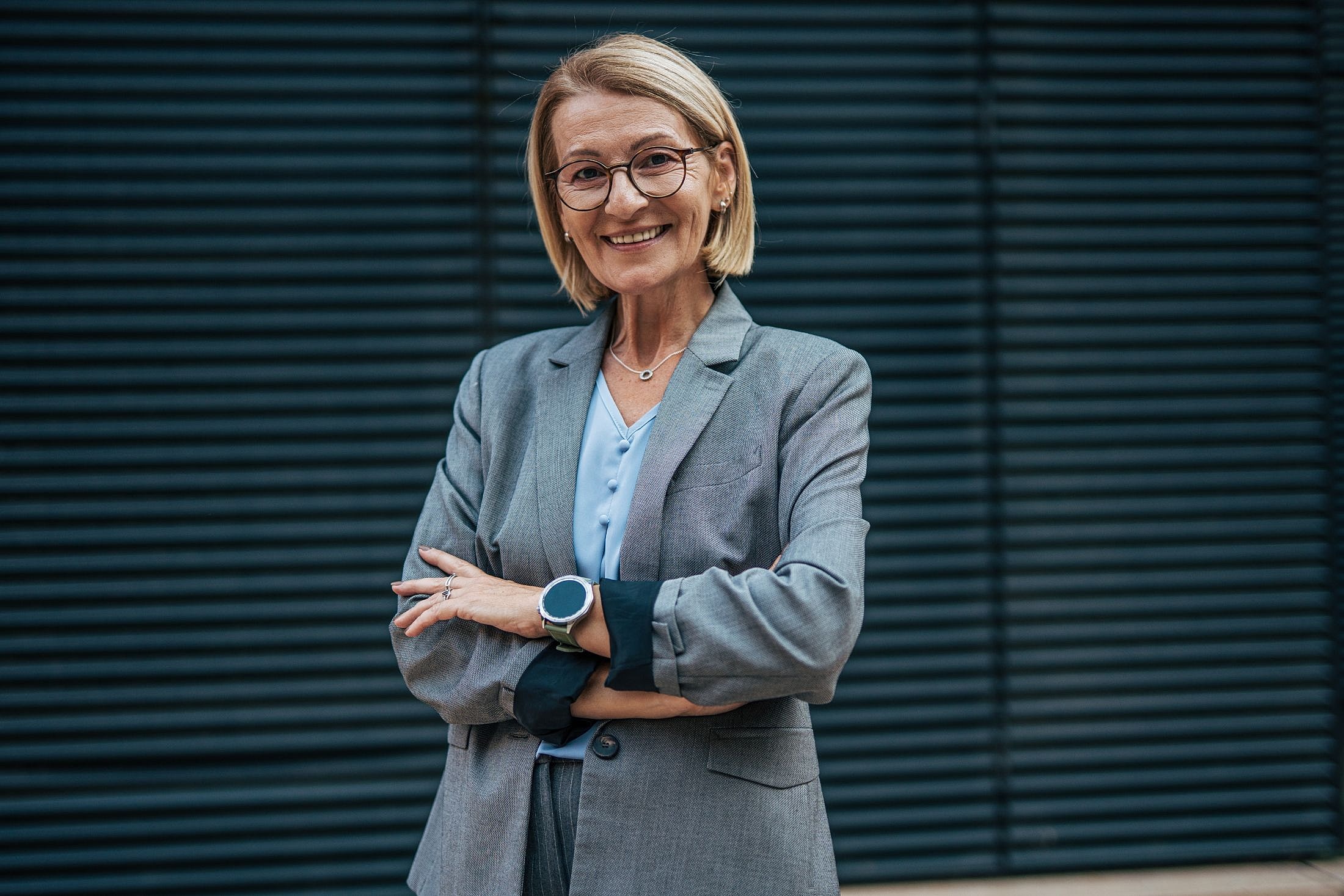 Professional woman smiling in a business suit.